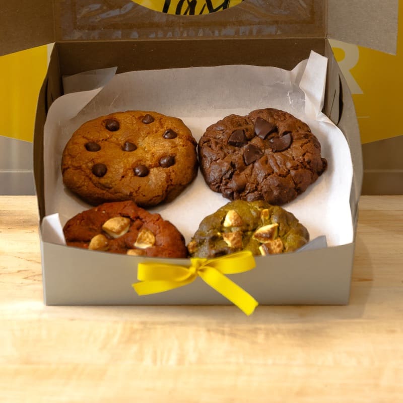 Taste Bender cookie assortment in a box with a yellow ribbon